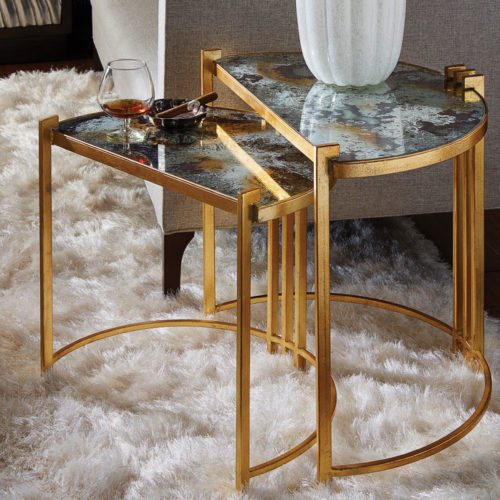 These Art Deco styled nested tables feature acid washed mirror tops on gold leafed finished frames. These tables come as a pair and would make a luxurious addition to any living room