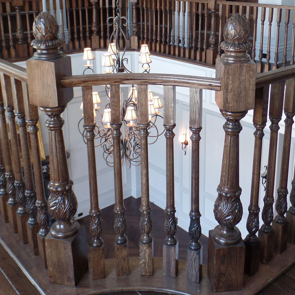 luxury interior with beautiful staircase railing featuring carved wood newels and balusters carved with acanthus leaf design; staircase design ideas; staircase inspiration