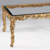 Rectangular carved wood coffee table with leaf motif. Carved coffee table has antiqued gold-leaf finish and thick beveled glass top. This carved wood table is hand-made in Italy