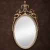 Adam style oval carved wood and wrought iron mirror with leaf drops and floral design. Mirror finished in antiqued gold leaf and silver leaf. Mirror has a beveled glass. This mirror is hand-crafted in Italy