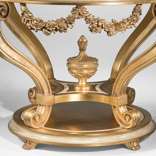 Louis XVI style round carved wood center table with antiqued gold-leaf finish. Louis XVI center table has antiqued ivory trim and Estremoz marble top with curved, beveled edge. This center table is hand made in Italy