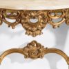 Louis XV style carved wood console with leaf scroll motif in antiqued gold leaf finish. Louis XV console has Calacotta gold marble top. This console table is hand made in Italy