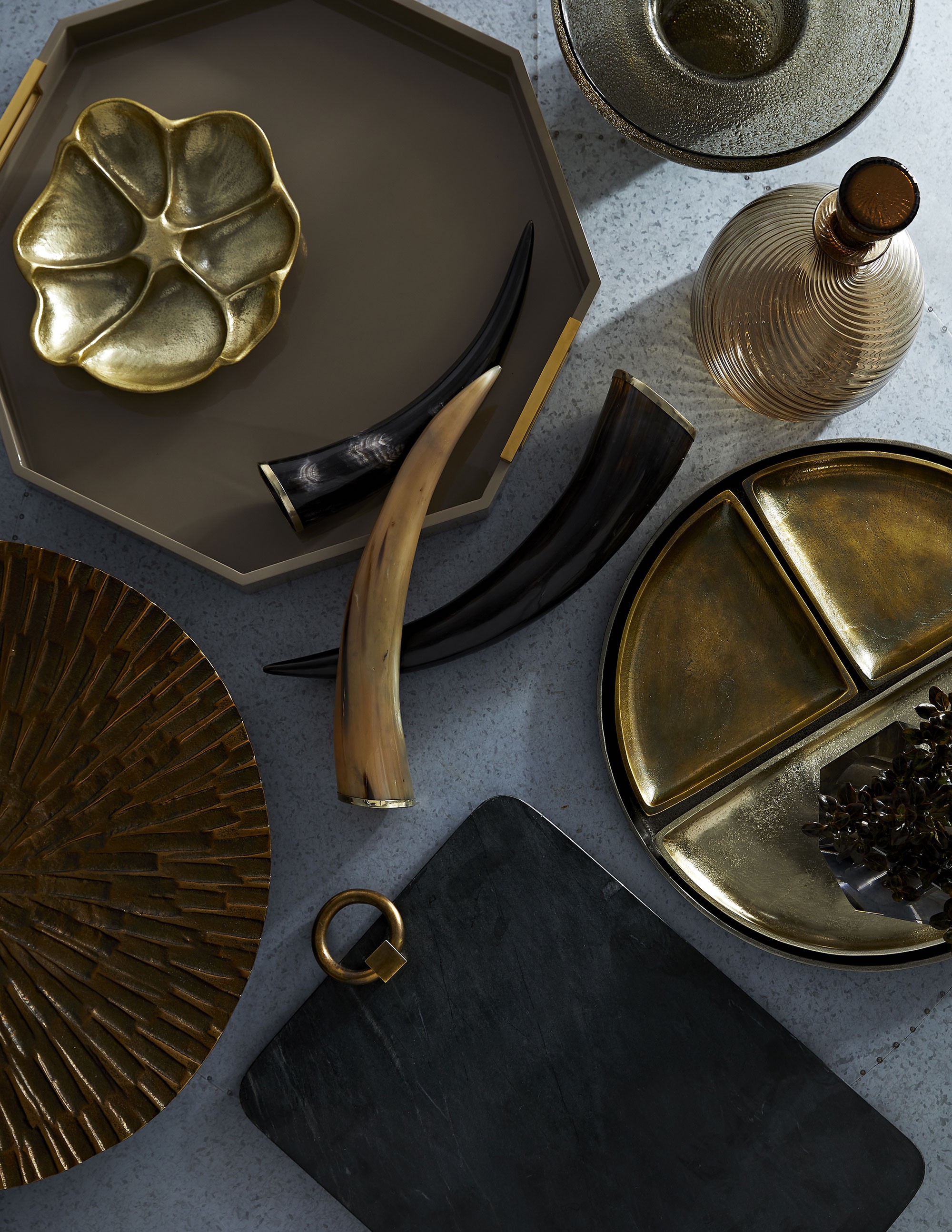 elegant and modern decorative accessories featuring poppy tray, horns and other antique brass accents.